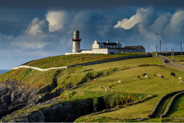 The view of the lighthouse from the Old Head of Kinsale, a golf tour provided by a private driver in Ireland.