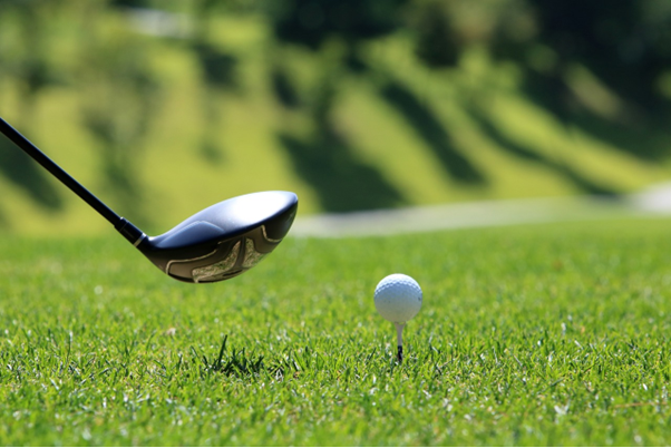 A golfer on a golf tour with a private driver in Ireland preparing to tee off.